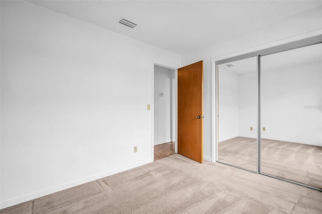 2749 Countryside Blvd Unit 20, Clearwater, FL 33761 - unfurnished bedroom featuring carpet, baseboards, and a closet