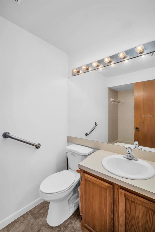 2749 Countryside Blvd Unit 20, Clearwater, FL 33761 - bathroom with toilet, vanity, and baseboards