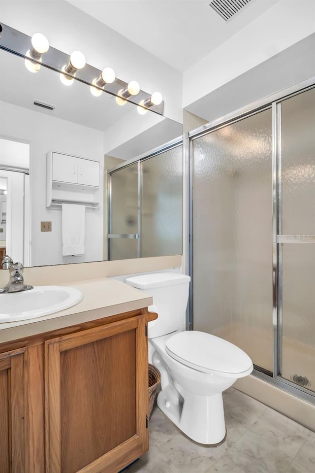 2749 Countryside Blvd Unit 20, Clearwater, FL 33761 - bathroom featuring vanity, a stall shower, and toilet