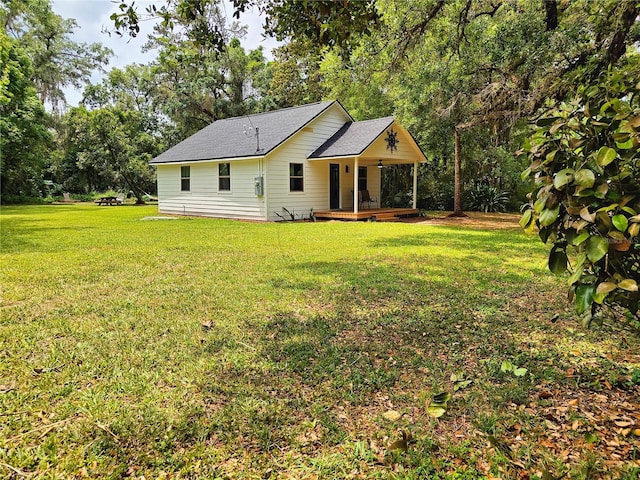 18452 Fort Dade Ave, Brooksville, FL 34601 - rear view of house with a yard and roof with shingles