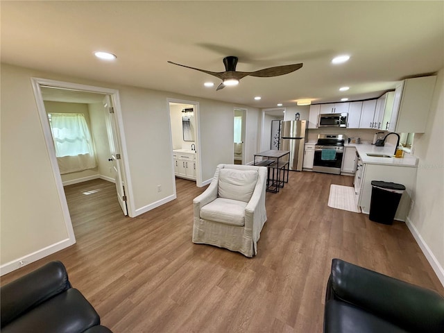 18452 Fort Dade Ave, Brooksville, FL 34601 - living area with recessed lighting, wood finished floors, baseboards, and a ceiling fan