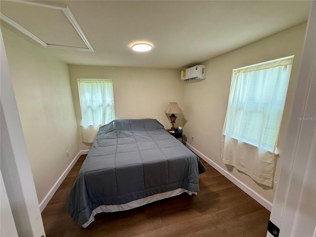 18452 Fort Dade Ave, Brooksville, FL 34601 - bedroom featuring a wall mounted AC, attic access, wood finished floors, and baseboards