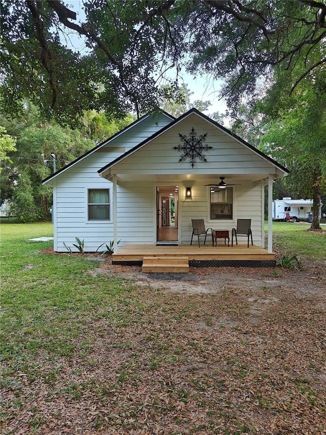 18452 Fort Dade Ave, Brooksville, FL 34601 - bungalow-style house featuring a porch, a front yard, and a ceiling fan