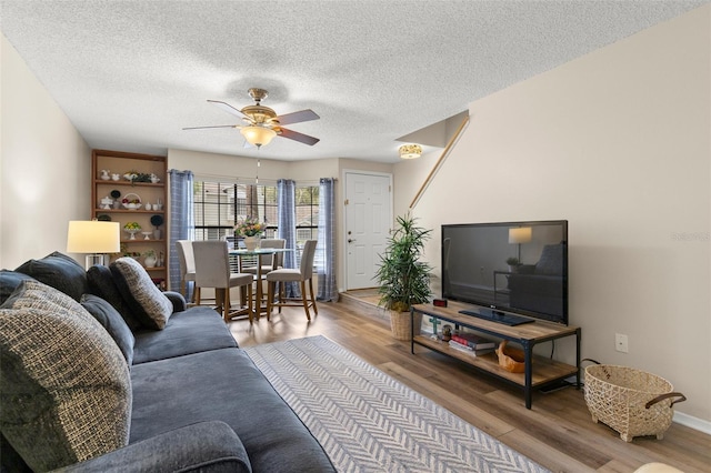 5100 Burchette Rd Unit 2702, Tampa, FL 33647 - living area featuring wood finished floors, ceiling fan, a textured ceiling, and baseboards