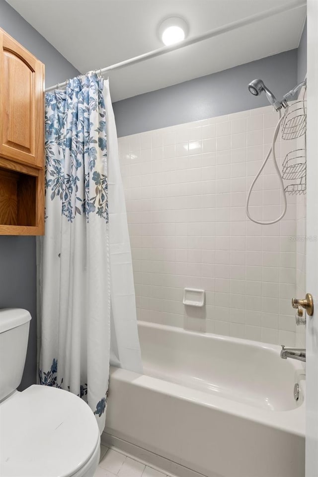 5100 Burchette Rd Unit 2702, Tampa, FL 33647 - bathroom featuring toilet, shower / bathtub combination with curtain, and tile patterned floors