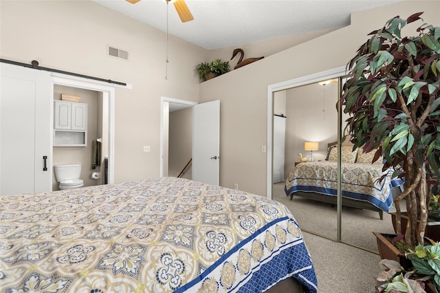 5100 Burchette Rd Unit 2702, Tampa, FL 33647 - bedroom with a barn door, carpet floors, a closet, a ceiling fan, and a high ceiling