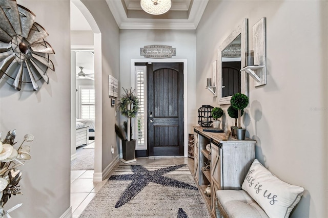 222 Toscavilla Blvd, Nokomis, FL 34275 - entrance foyer featuring arched walkways, crown molding, light tile patterned flooring, and a tray ceiling