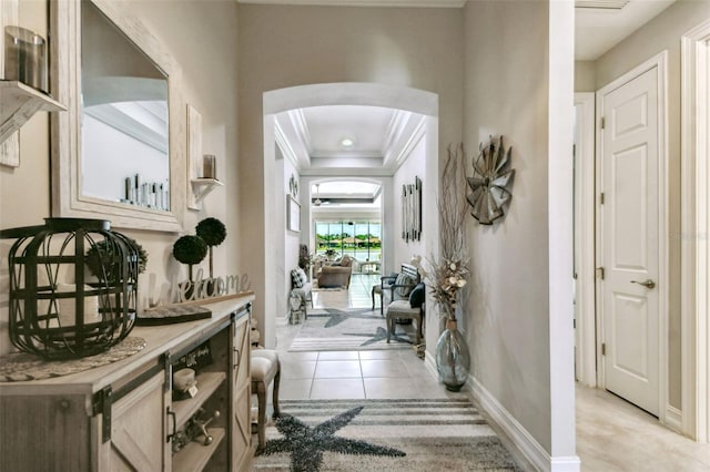 222 Toscavilla Blvd, Nokomis, FL 34275 - hall featuring arched walkways, crown molding, a tray ceiling, and light tile patterned floors