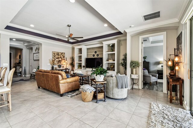 222 Toscavilla Blvd, Nokomis, FL 34275 - living room with ceiling fan, arched walkways, light tile patterned flooring, ornamental molding, and a tray ceiling