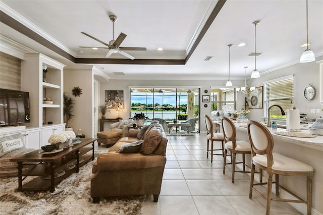 222 Toscavilla Blvd, Nokomis, FL 34275 - living area featuring a ceiling fan, ornamental molding, recessed lighting, light tile patterned flooring, and a tray ceiling