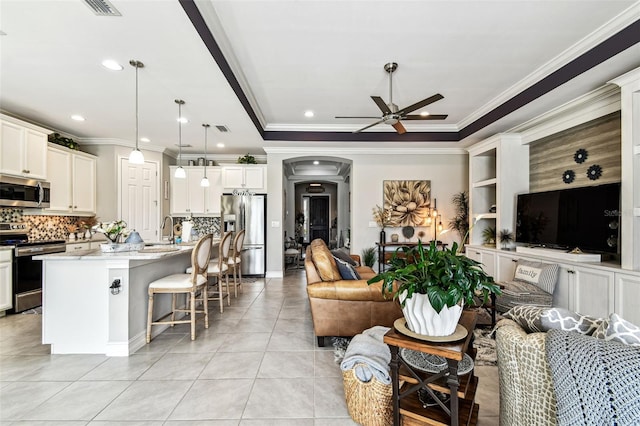 222 Toscavilla Blvd, Nokomis, FL 34275 - living area featuring ceiling fan, light tile patterned floors, ornamental molding, arched walkways, and recessed lighting