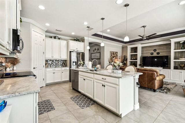 222 Toscavilla Blvd, Nokomis, FL 34275 - kitchen with stainless steel appliances, light tile patterned floors, crown molding, ceiling fan, and decorative backsplash
