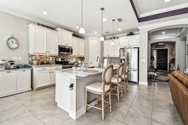 222 Toscavilla Blvd, Nokomis, FL 34275 - kitchen with stainless steel appliances, tasteful backsplash, light tile patterned floors, ornamental molding, and recessed lighting