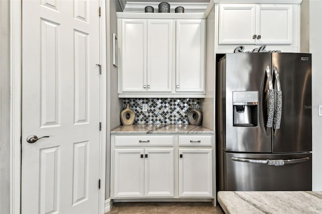 222 Toscavilla Blvd, Nokomis, FL 34275 - kitchen with stainless steel fridge with ice dispenser, white cabinetry, and backsplash
