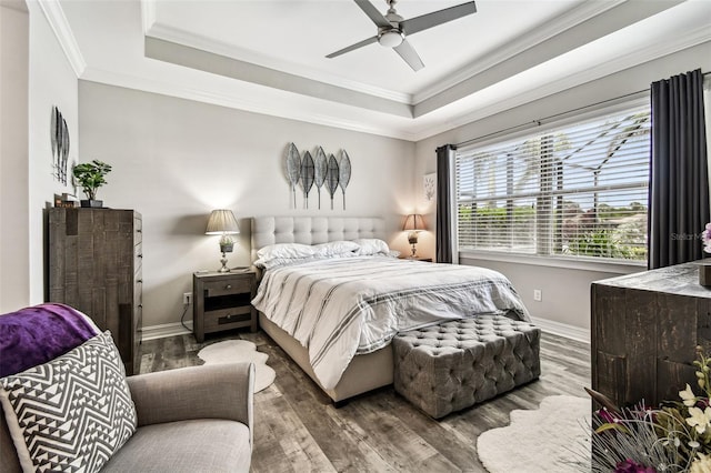 222 Toscavilla Blvd, Nokomis, FL 34275 - bedroom featuring a tray ceiling, wood finished floors, crown molding, and ceiling fan