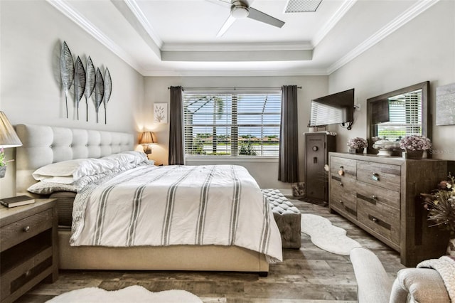 222 Toscavilla Blvd, Nokomis, FL 34275 - bedroom featuring a tray ceiling, ornamental molding, wood finished floors, and a ceiling fan