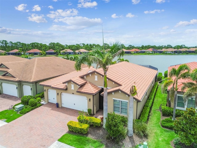 222 Toscavilla Blvd, Nokomis, FL 34275 - view of front of house featuring stucco siding, decorative driveway, an attached garage, a residential view, and a tiled roof