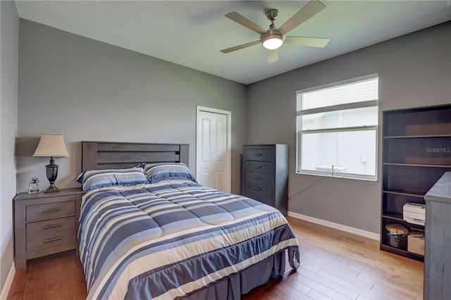 3813 Salida Delsol Dr, Sun City Center, FL 33573 - bedroom featuring baseboards, wood finished floors, a closet, and a ceiling fan