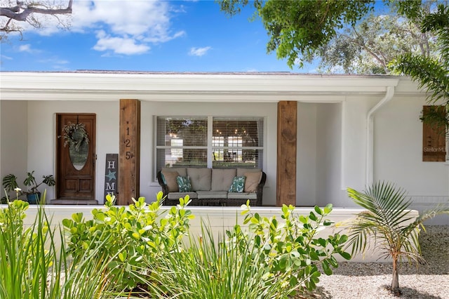 125 Live Oak Ln, Largo, FL 33770 - view of exterior entry with a porch, an outdoor hangout area, and stucco siding