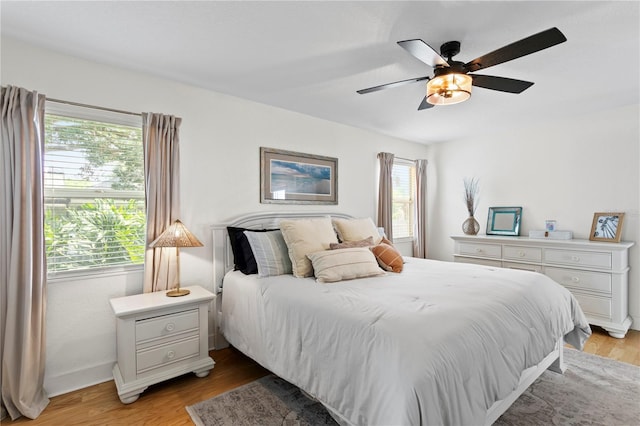 125 Live Oak Ln, Largo, FL 33770 - bedroom with light wood-style floors, ceiling fan, and baseboards