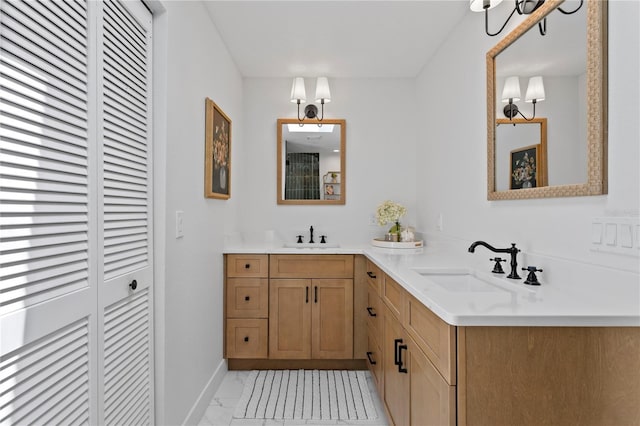 125 Live Oak Ln, Largo, FL 33770 - full bath featuring marble look tile flooring, double vanity, a closet, and baseboards