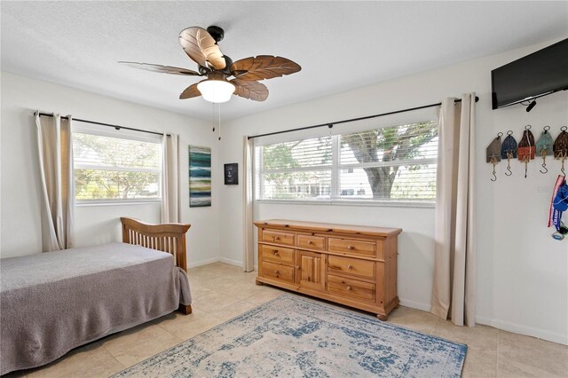 125 Live Oak Ln, Largo, FL 33770 - bedroom featuring light tile patterned floors, a ceiling fan, and baseboards