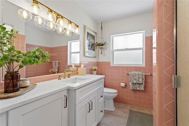 125 Live Oak Ln, Largo, FL 33770 - bathroom with tile walls, toilet, vanity, tile patterned flooring, and tiled shower