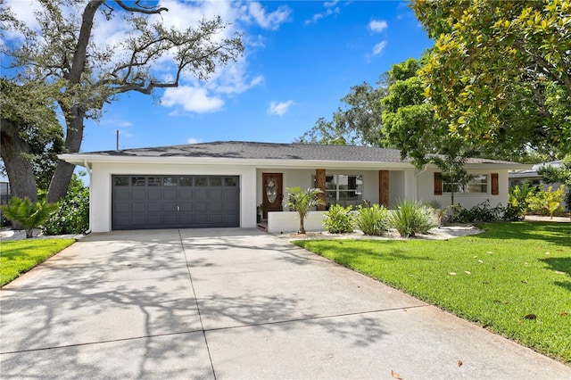 125 Live Oak Ln, Largo, FL 33770 - single story home with a garage, driveway, a front lawn, and stucco siding
