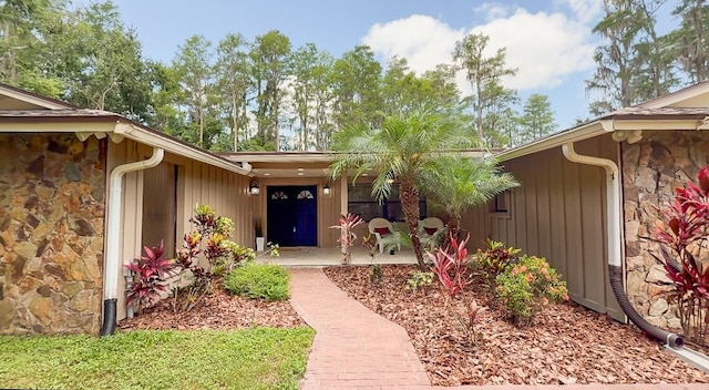 1025 Reading Rd, Lutz, FL 33558 - view of exterior entry with stone siding and covered porch