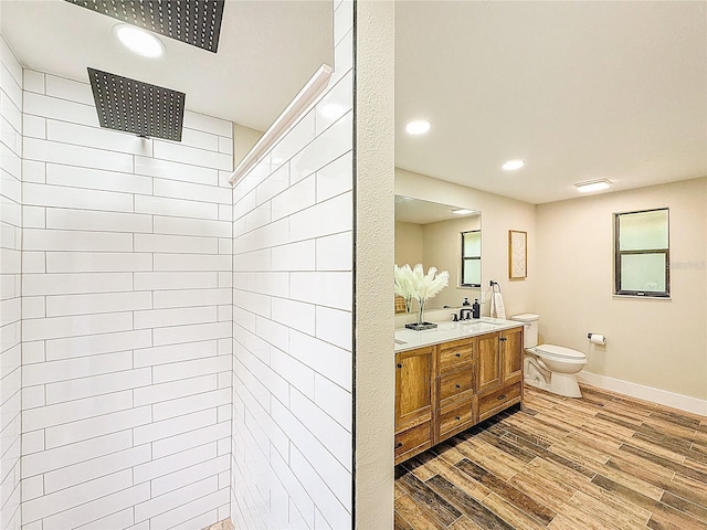 1025 Reading Rd, Lutz, FL 33558 - full bathroom featuring wood finished floors, double vanity, walk in shower, toilet, and recessed lighting