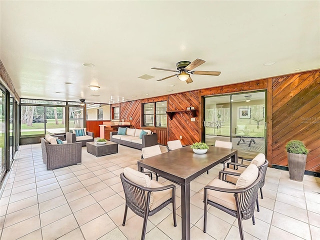 1025 Reading Rd, Lutz, FL 33558 - dining room with a ceiling fan, wood walls, and light tile patterned floors