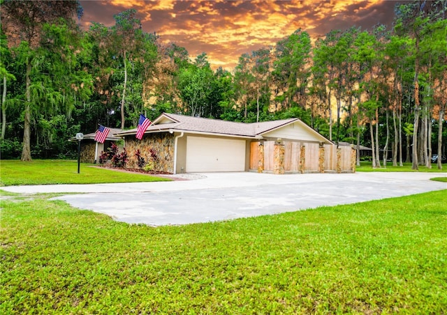 1025 Reading Rd, Lutz, FL 33558 - view of front of home with a garage, a front yard, concrete driveway, and view of wooded area