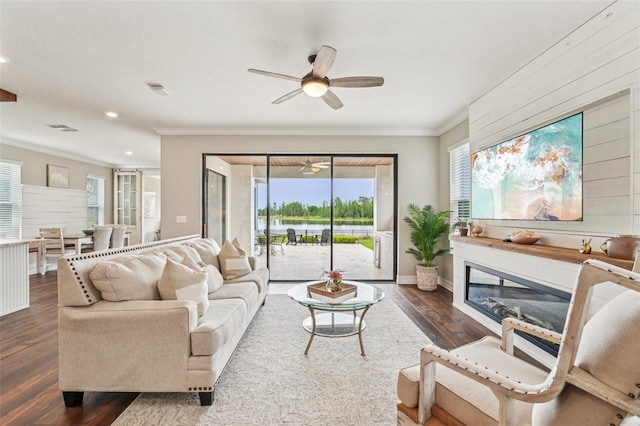 19191 Pease Pl, Lutz, FL 33558 - living room featuring a ceiling fan, ornamental molding, dark wood-type flooring, a water view, and recessed lighting