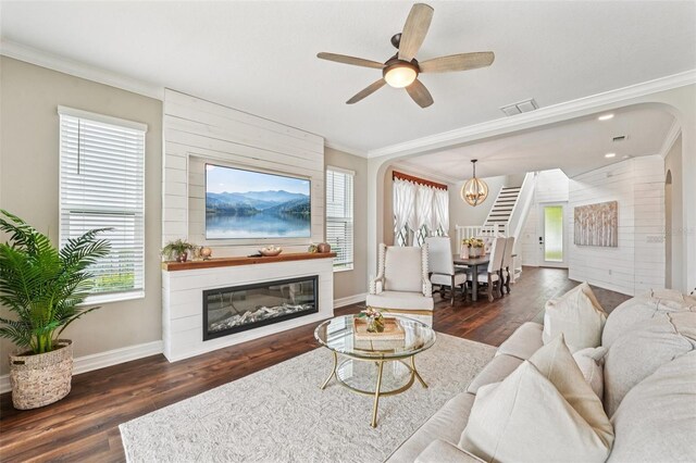 19191 Pease Pl, Lutz, FL 33558 - living room with ornamental molding, wood finished floors, baseboards, arched walkways, and a large fireplace
