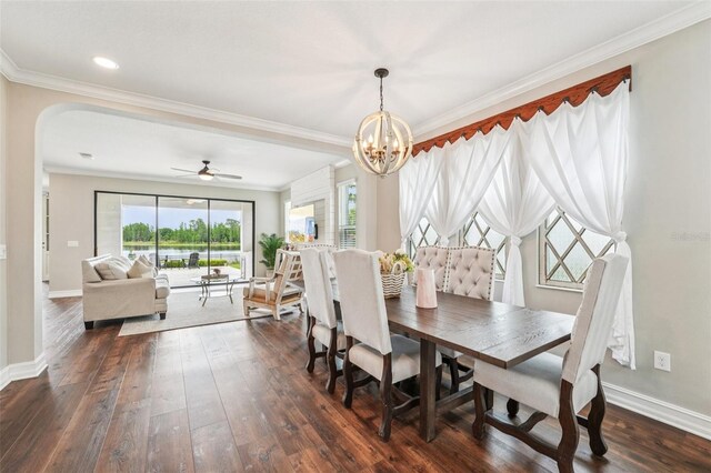 19191 Pease Pl, Lutz, FL 33558 - dining area with dark wood-type flooring, arched walkways, crown molding, baseboards, and a chandelier