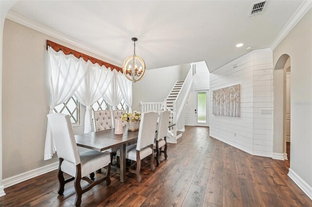 19191 Pease Pl, Lutz, FL 33558 - dining room featuring arched walkways, crown molding, a chandelier, baseboards, and dark wood finished floors