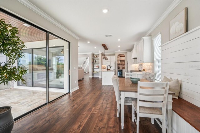 19191 Pease Pl, Lutz, FL 33558 - dining space with ornamental molding, dark wood-style floors, stairway, and recessed lighting