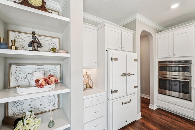 19191 Pease Pl, Lutz, FL 33558 - kitchen with double oven, ornamental molding, arched walkways, open shelves, and white cabinetry