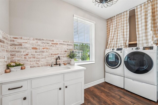 19191 Pease Pl, Lutz, FL 33558 - laundry room featuring washer and dryer, plenty of natural light, dark wood-style flooring, and cabinet space
