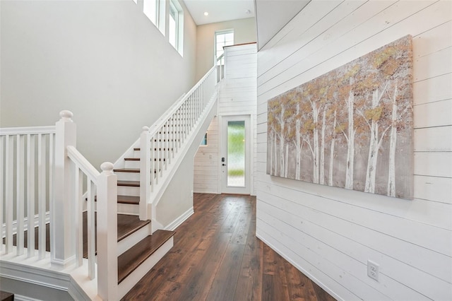 19191 Pease Pl, Lutz, FL 33558 - stairs with wooden walls, a towering ceiling, and hardwood / wood-style floors
