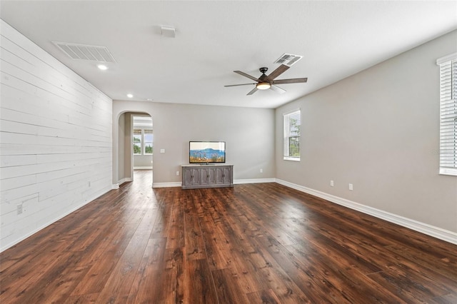 19191 Pease Pl, Lutz, FL 33558 - unfurnished living room with dark wood-style flooring, ceiling fan, arched walkways, recessed lighting, and baseboards