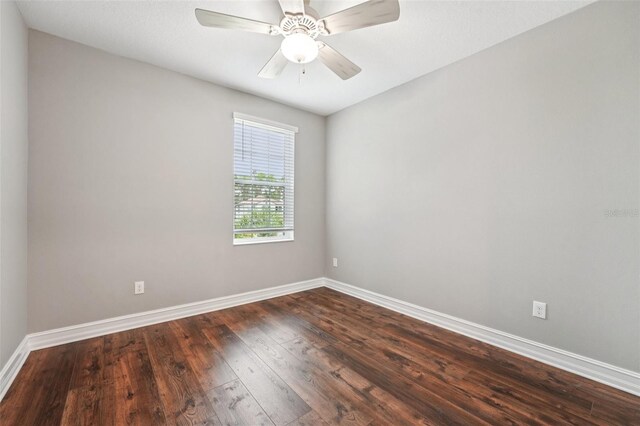 19191 Pease Pl, Lutz, FL 33558 - empty room with dark wood finished floors, baseboards, and a ceiling fan