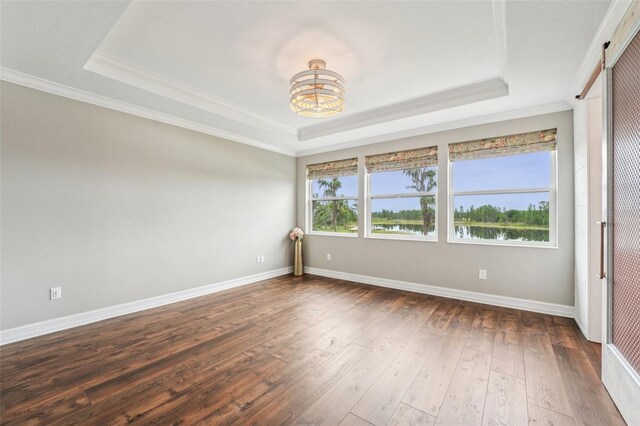 19191 Pease Pl, Lutz, FL 33558 - empty room featuring a tray ceiling, a chandelier, crown molding, dark wood-style flooring, and baseboards
