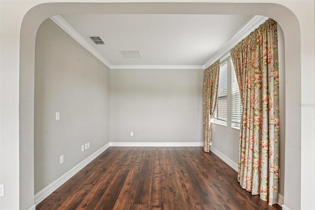 19191 Pease Pl, Lutz, FL 33558 - empty room with crown molding, dark wood-type flooring, baseboards, and arched walkways