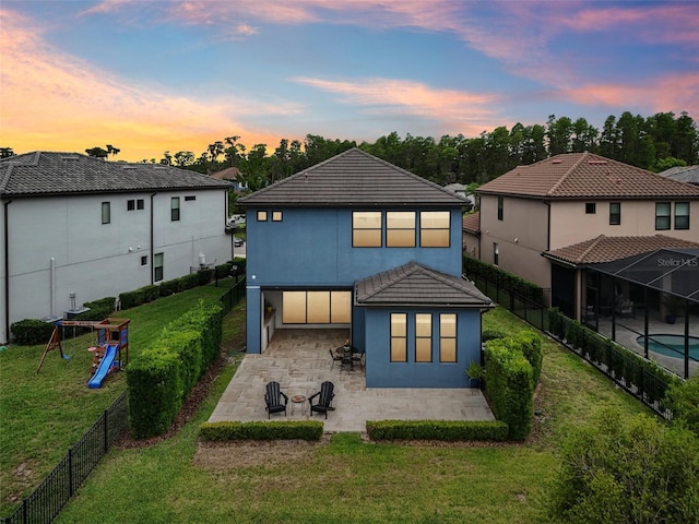19191 Pease Pl, Lutz, FL 33558 - rear view of house with a patio area, stucco siding, a playground, and a tile roof