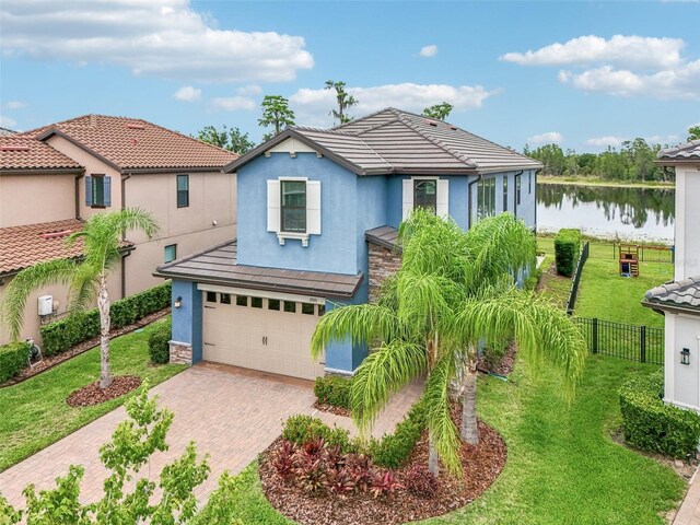 19191 Pease Pl, Lutz, FL 33558 - view of front of house featuring stucco siding, a water view, decorative driveway, a garage, and a tile roof