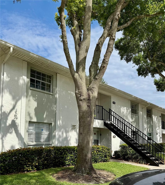 3802 N Oak Dr Unit W22, Tampa, FL 33611 - view of property exterior featuring stairs and stucco siding