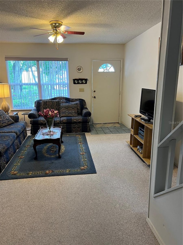 7616 Colonial Ct, Tampa, FL 33615 - carpeted living room featuring a ceiling fan and a textured ceiling