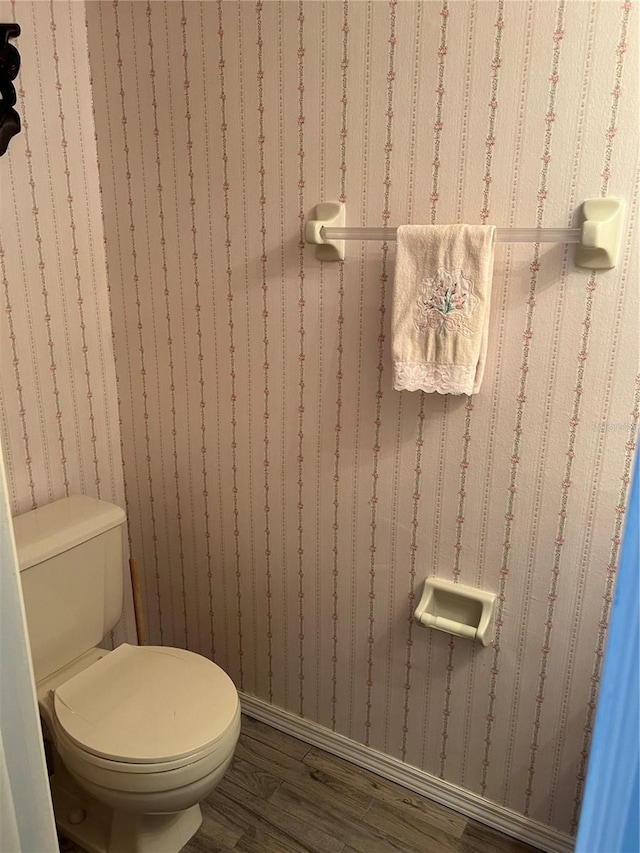 7616 Colonial Ct, Tampa, FL 33615 - bathroom with wood finished floors, toilet, and baseboards