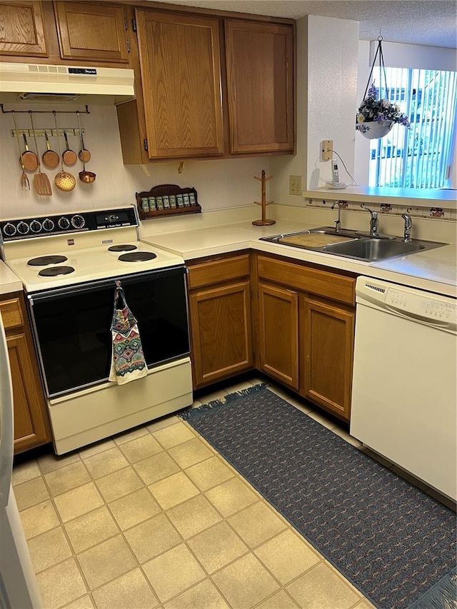 7616 Colonial Ct, Tampa, FL 33615 - kitchen with electric range, white dishwasher, a sink, under cabinet range hood, and light countertops